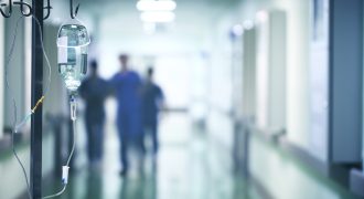 hospital hallway with doctors running