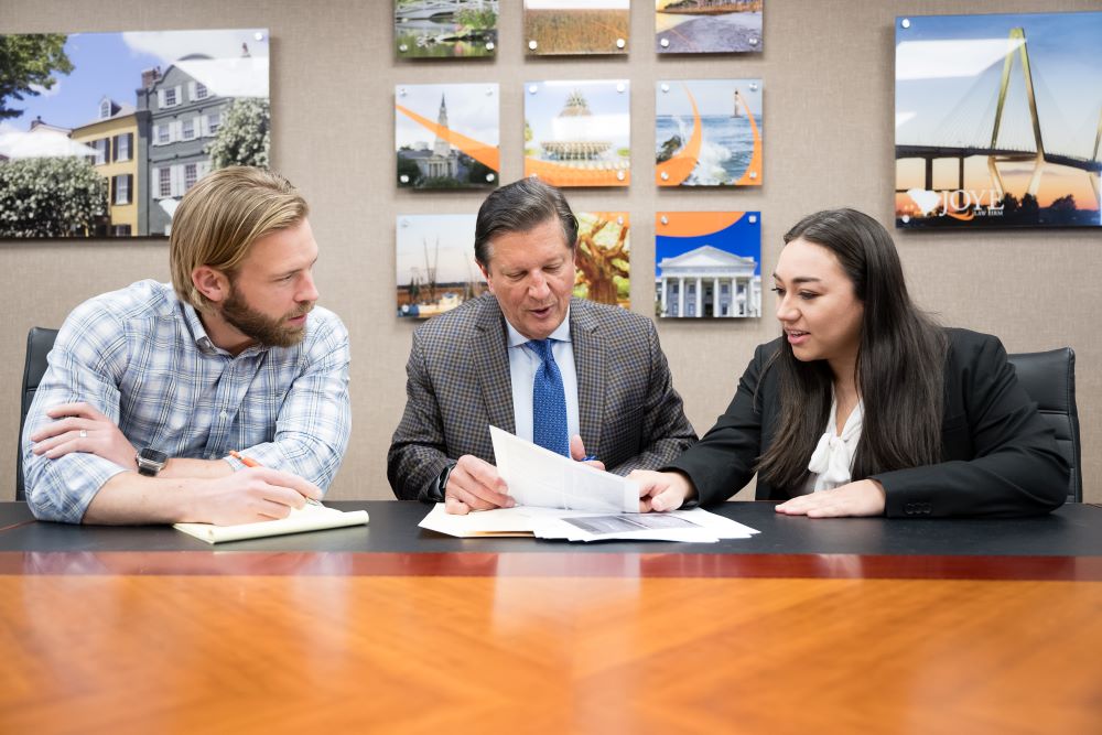 Three Joye Law Firm Attorneys sitting at a table discussing a case