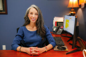 Melissa Mosier smiling at her desk