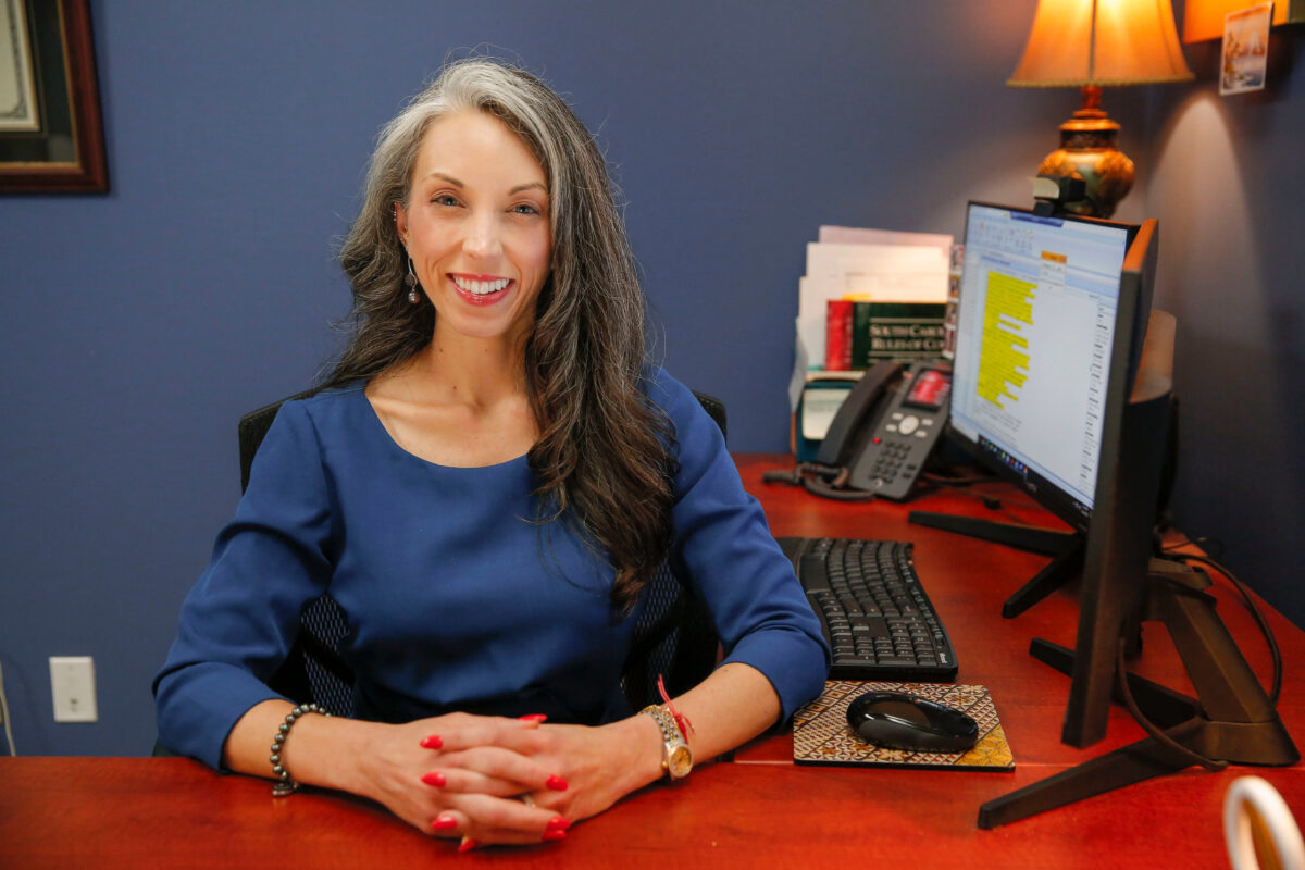 Attorney Melissa Mosier at her desk in the Columbia office