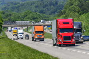 A steady flow of semis lead the way down a busy interstate highway