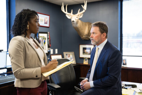 Case Manager Cierra Grier and Partner Mark Joye discuss a car accident case in the North Charleston office on Rivers Avenue