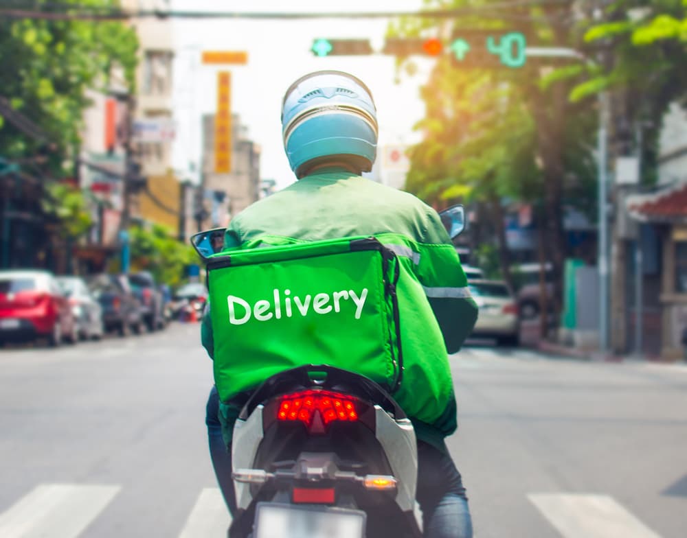 Food delivery drivers are transporting orders to customers who shop online. Epidemics have heightened demand, impacting driver workload and road safety.