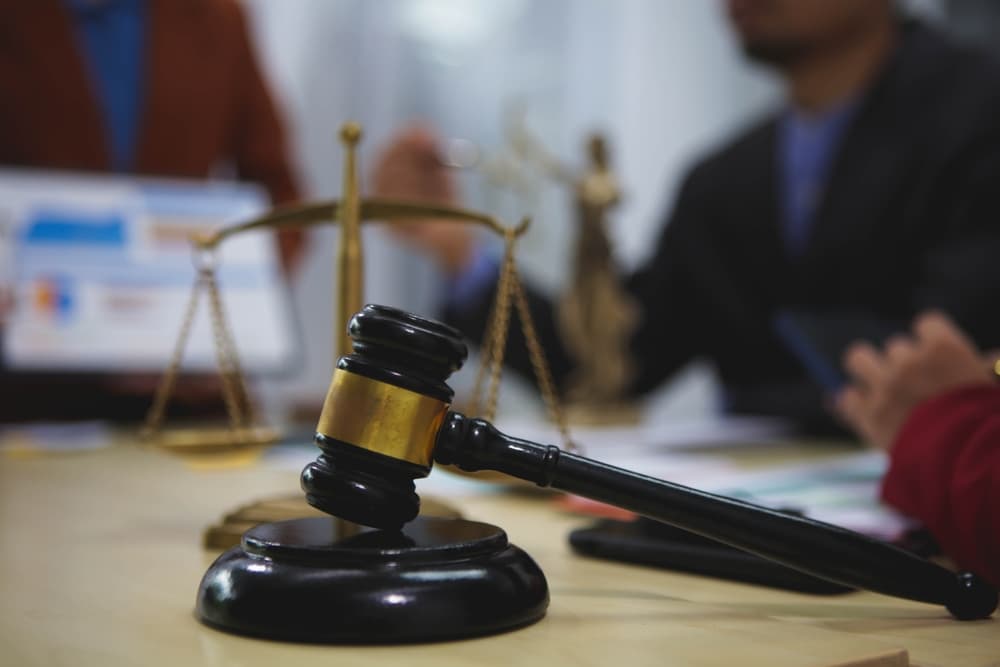 Close-up of gavel, scales of justice, and legal documents in a personal injury attorney's office.