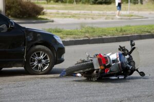 Motorcycle and car collision on the road. 